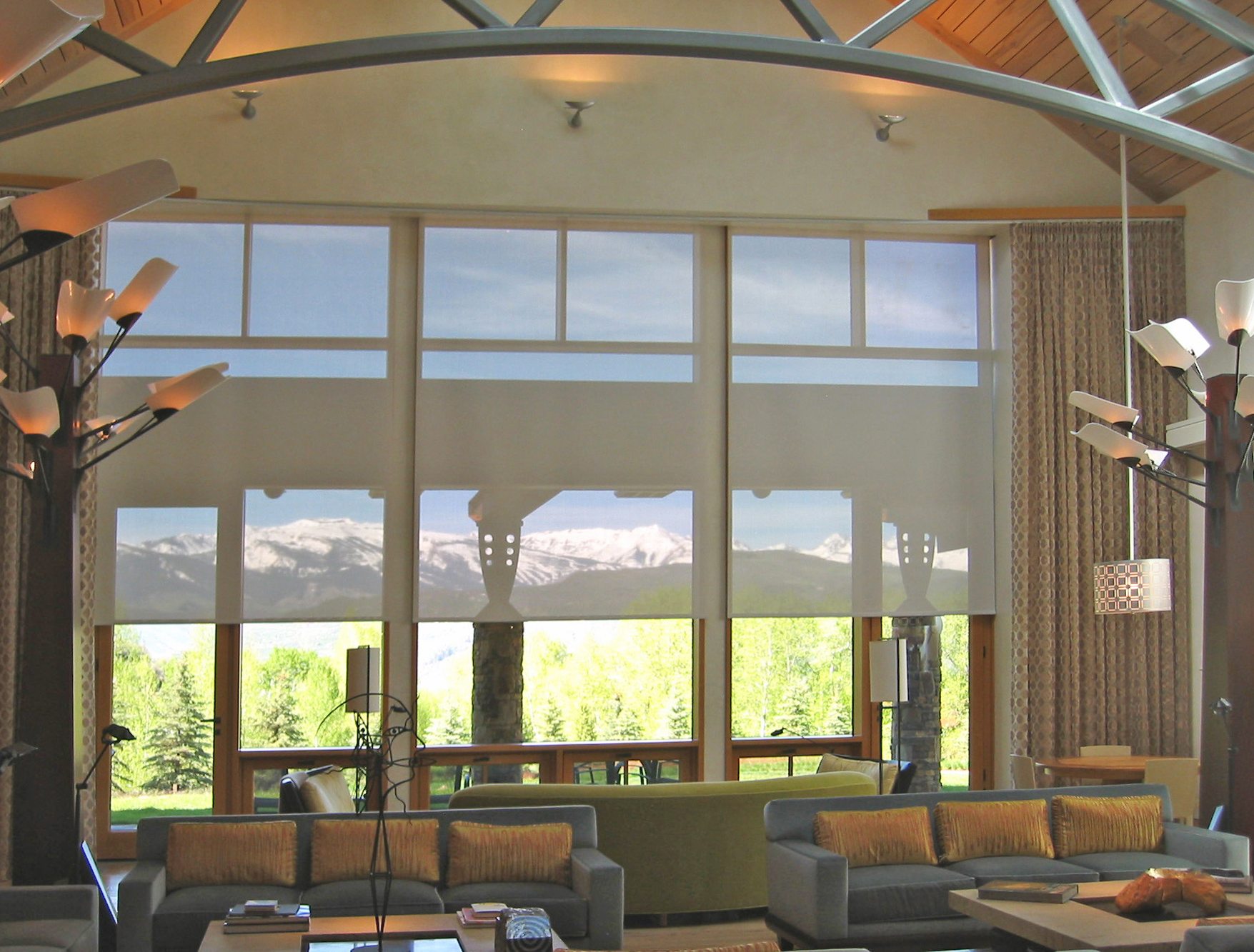 Screen roller shades in large room with mountain views.