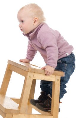 baby on climbing on chair