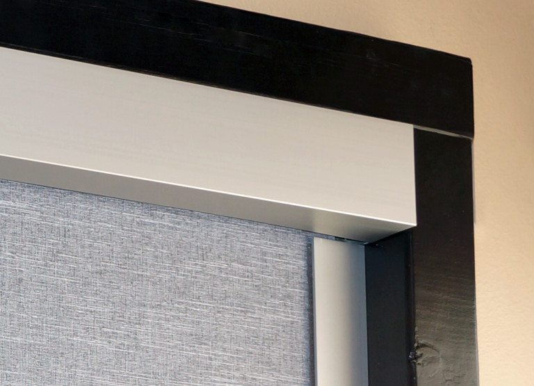 Insolroll Blackout shades in decorative fabric with clear anodized fascia to cover the roller