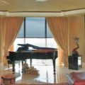 Insolroll solar shades paired with draperies protect piano from UV rays