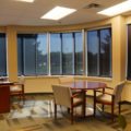 Office with rounded corner windows solar shades