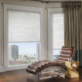 Sonnette cellular roller shades sitting window city view