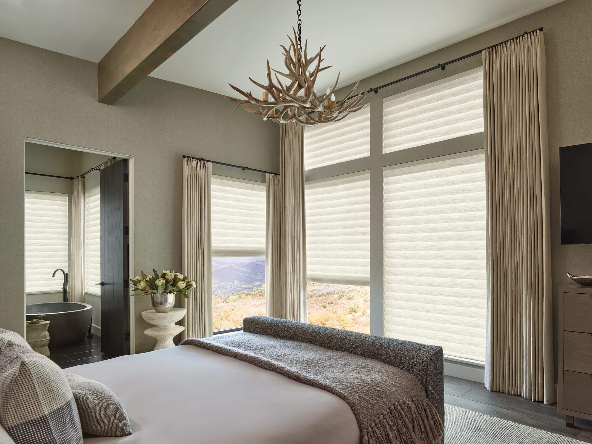 Soft fabric Vignette roman shades are harmonious with this Northern Colorado foothills view